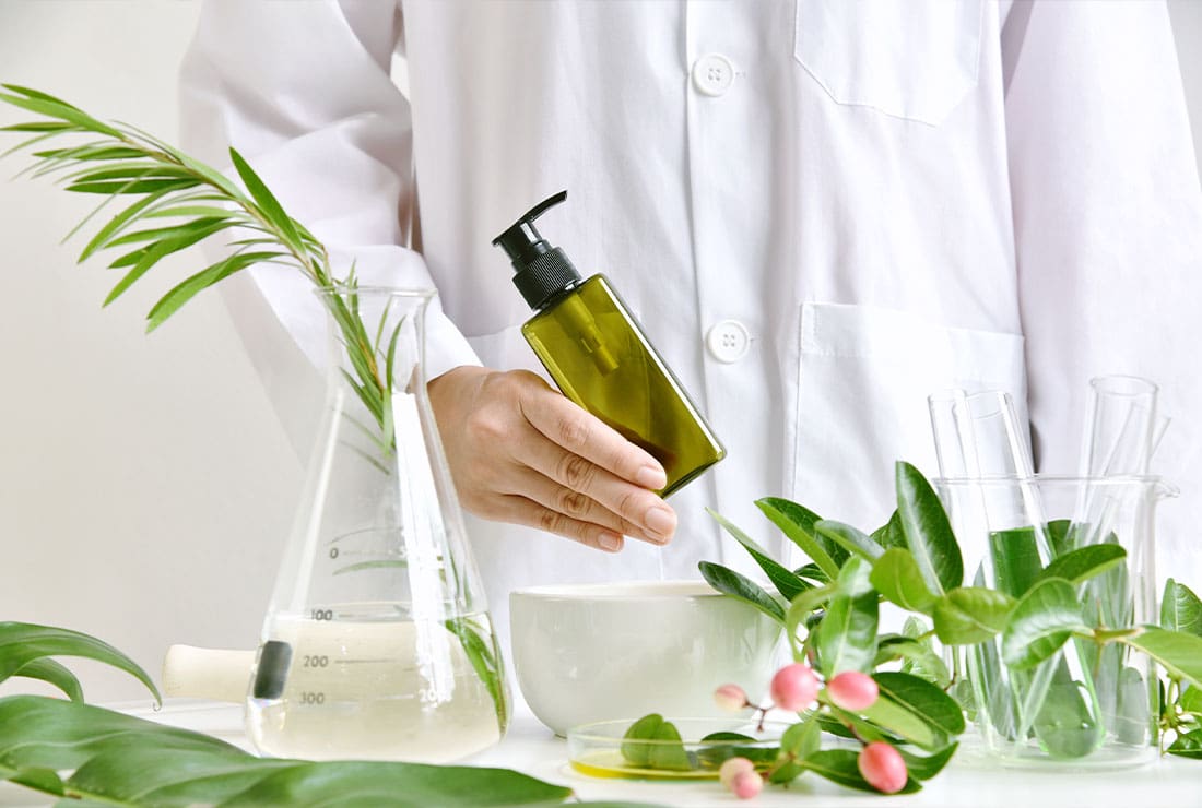 Lab researcher holding a bottle of cosmetic product
